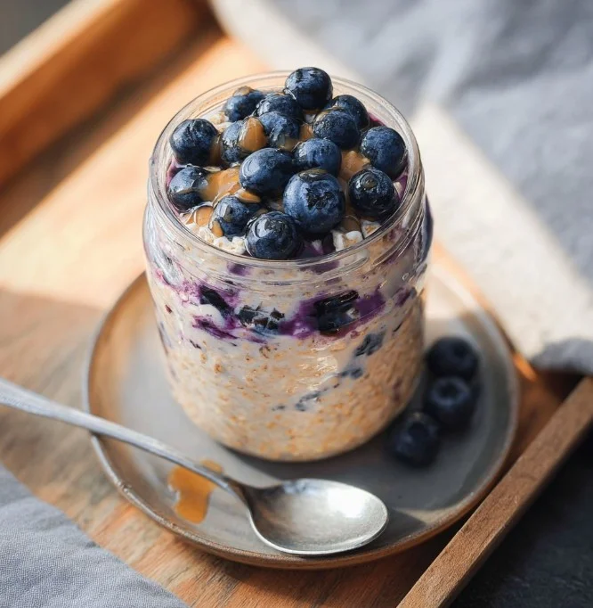 Delicious blueberry overnight oats served in a bowl with fresh berrieBlueberry Overnight Oatss on top.