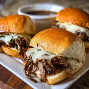 Delicious Crock Pot French Dip Sandwiches served with dipping sauce.