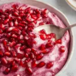 Dairy-free cranberry fluff dessert in a bowl with cranberries on top.
