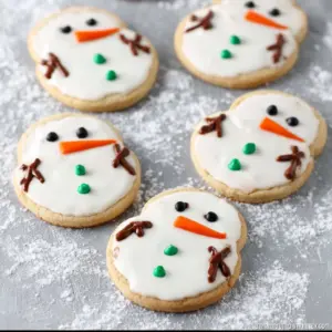 Adorable melting snowman cookies decorated with icing and candy