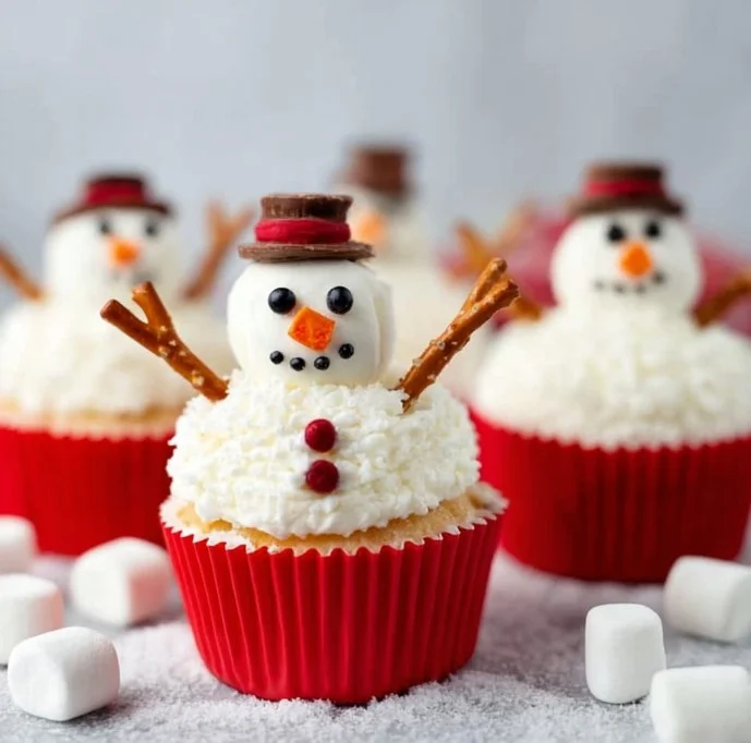 Delicious melting snowman cupcakes decorated for festive celebrations.