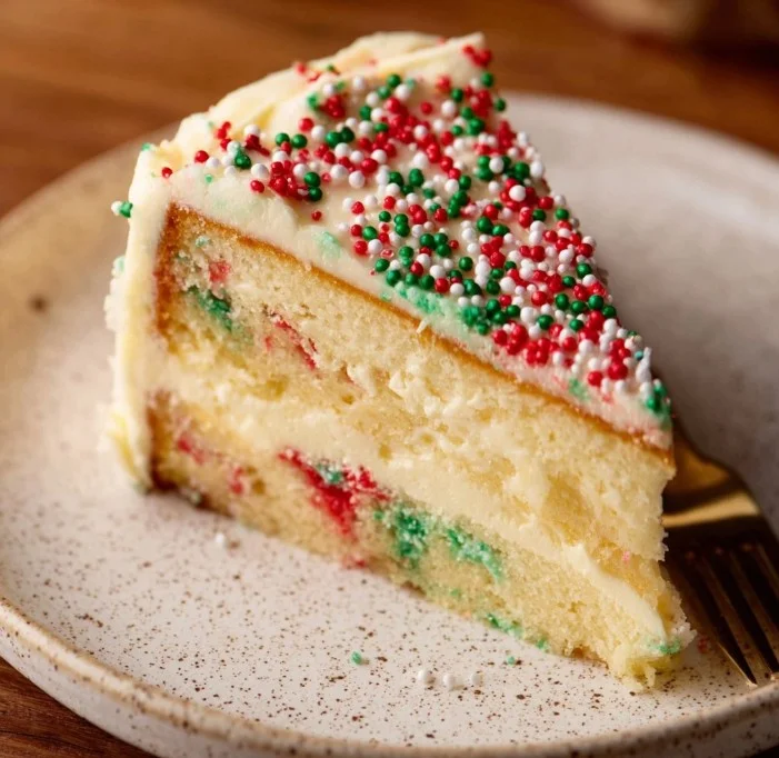 Delicious slice of Sugar Cookie Cheesecake topped with sugar cookie crumbles