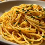 Delicious Cowboy Butter Spaghetti served with fresh herbs and spices.