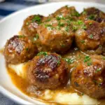 Salisbury steak meatballs cooked in a slow cooker with savory gravy.