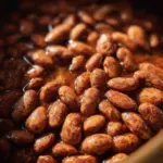 Plate of slow cooked pinto beans garnished with herbs and spices