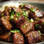 Tender crockpot steak bites with garlic butter served on a plate