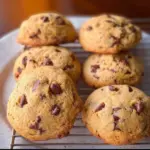 Freshly baked banana chocolate chip cookies on a cooling rack