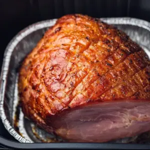 Deliciously cooked Air Fryer Ham garnished and served on a platter.