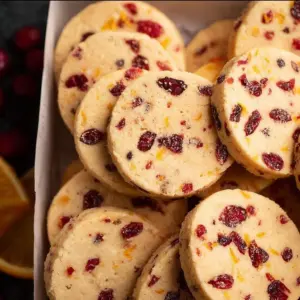 Cranberry orange shortbread cookies on a plate, festive treat for any occasion.