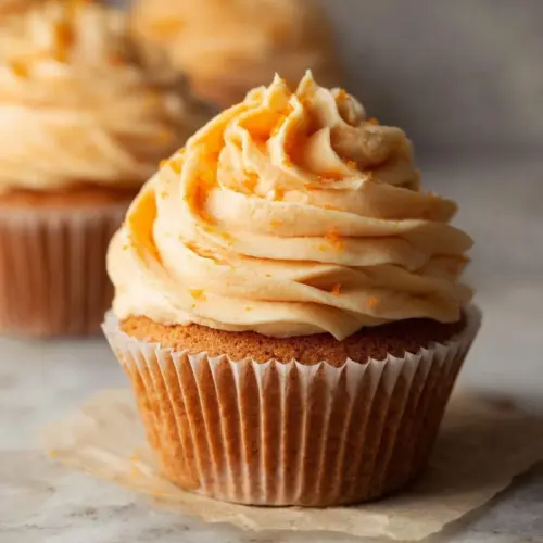 Delicious orange buttercream frosting on a cake