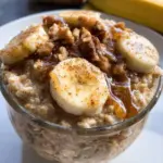 Bowl of banana bread overnight oats topped with banana slices and nuts
