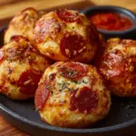 Cheesy pepperoni pizza bombs served on a plate, ready to eat