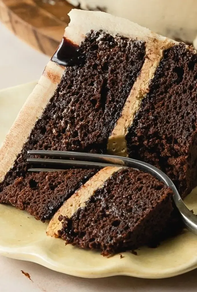 Delicious slice of Chocolate Coffee Cake with chocolate frosting and coffee beans.