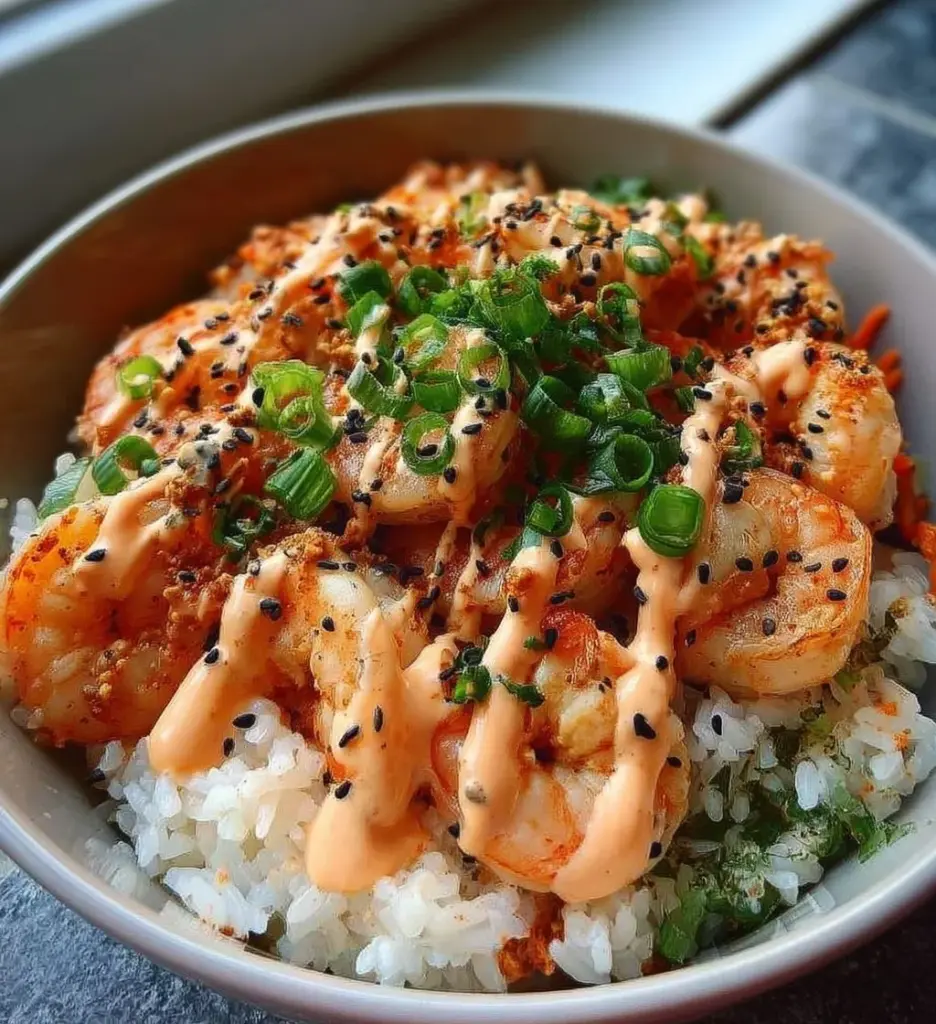 Delicious shrimp rice bowl topped with spicy mayo and fresh vegetables