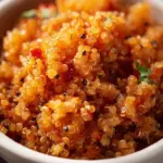 A vibrant bowl of Spanish Quinoa with vegetables and spices.