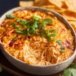 Delicious Spicy Chicken Dip served in a bowl with tortilla chips.