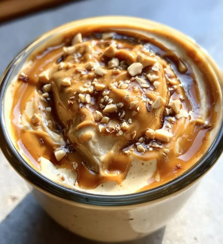 Cottage cheese peanut butter mousse in a bowl, garnished with chocolate shavings.