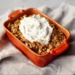 Healthy Protein Apple Crisp dessert topped with oats and nuts