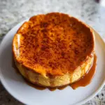 Slice of Pumpkin Cottage Cheese Cheesecake on a plate with autumn decorations