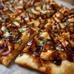 BBQ Chicken Flatbread with grilled chicken and fresh toppings on a rustic platter