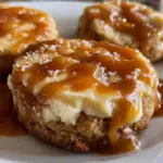 Cheesecake cookies topped with creamy caramel drizzle, delicious dessert treat.