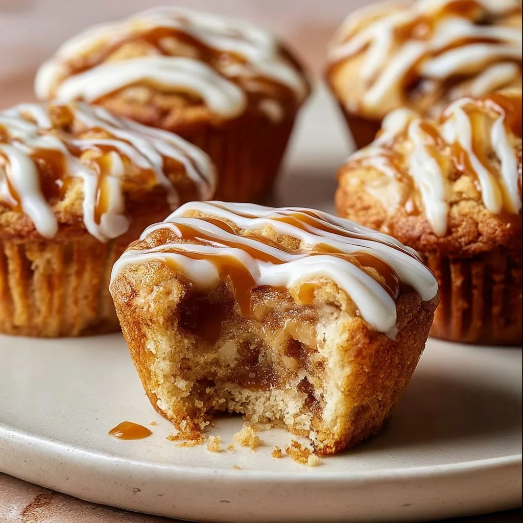 Delicious Cinnamon Roll Protein Muffins on a plate, topped with icing