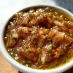 Bowl of Colombian Aji sauce with fresh ingredients and spices.