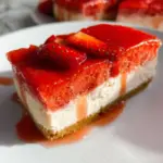 Easy vegan strawberry cheesecake topped with fresh strawberries.
