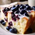 Heavenly moist blueberry lemon angel food cake on a serving plate