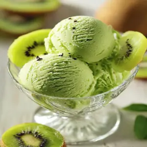 Bowl of fresh kiwi sorbet served with slices of kiwi on top