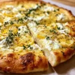 Lemon Pizza with Ricotta, Mozzarella, and Fresh Thyme on a wooden board