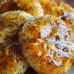 Freshly baked orange poppy seed cookies on a cooling rack