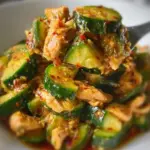 Thai cucumber salad with chicken, showcasing fresh ingredients and vibrant presentation.