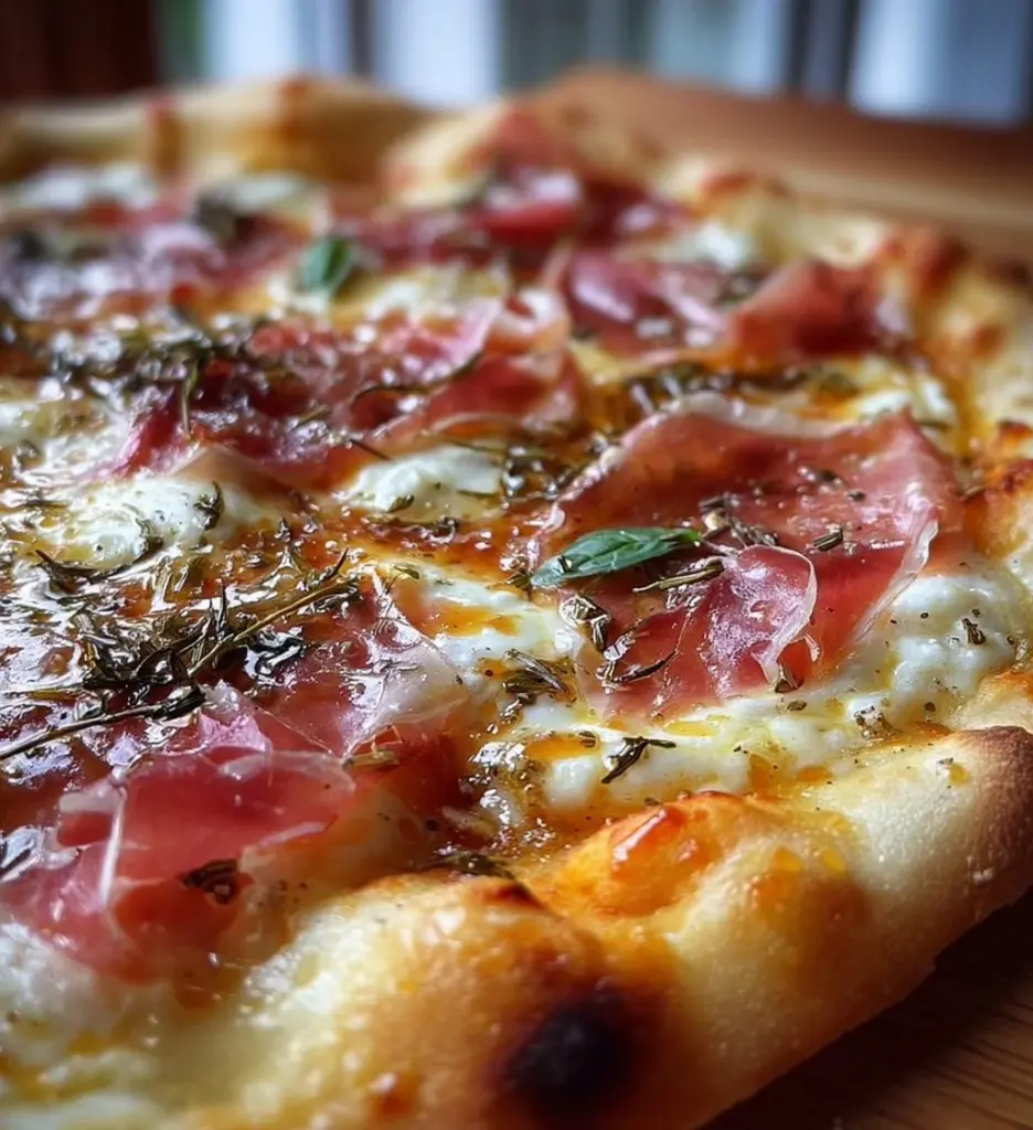 White pizza topped with prosciutto and drizzled with hot honey